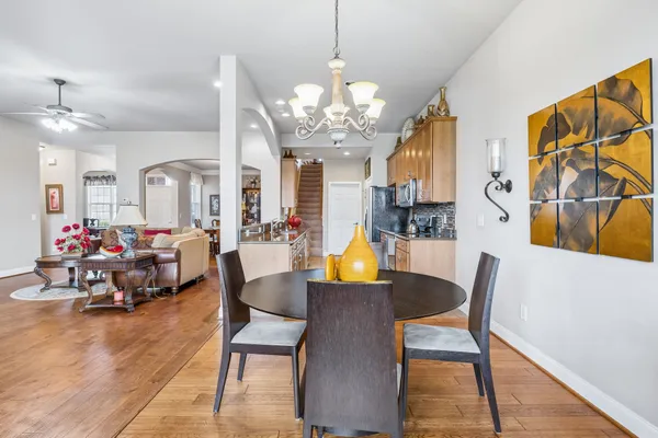 a view of a dining room with furniture and a chandelier