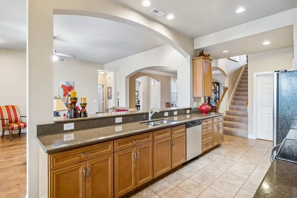 a large kitchen with lots of counter space and sink