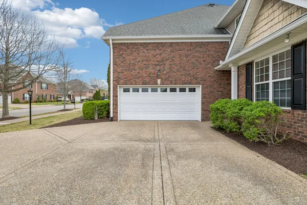 a view of entrance gate of house and car parked