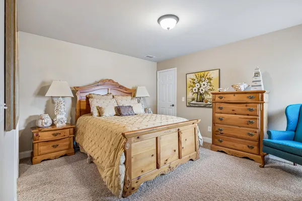 a bedroom with a bed and a dresser