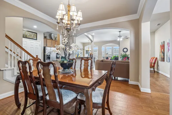 a view of a dining room with furniture and chandelier