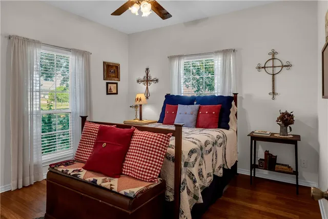 a bedroom with bed and wooden floor