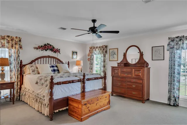 a bedroom with furniture and a mirror