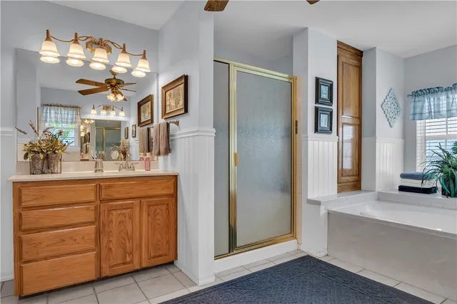 a spacious bathroom with a double vanity sink a mirror and a shower