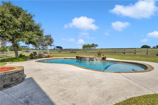 a view of a swimming pool and a yard
