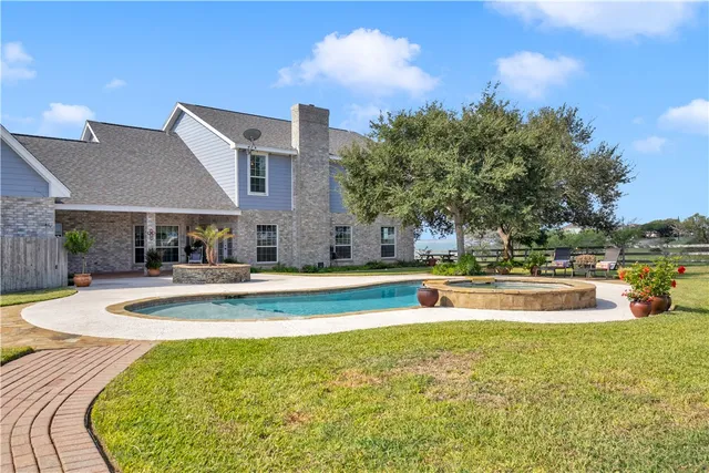 a view of an house with swimming pool and sitting area