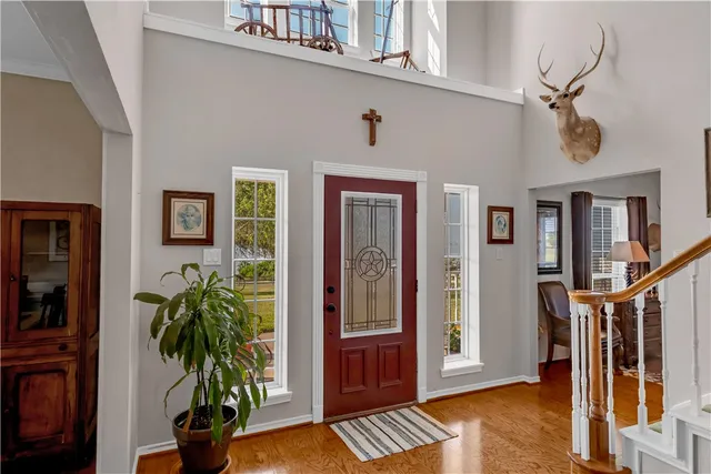 a view of an entryway with wooden floor and front door
