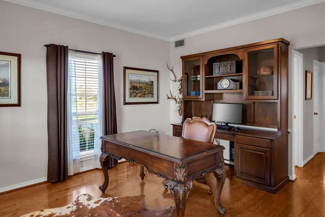 a workspace with furniture and wooden floor