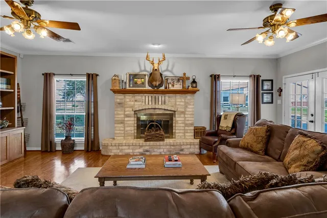 a living room with furniture a flat screen tv and a fireplace
