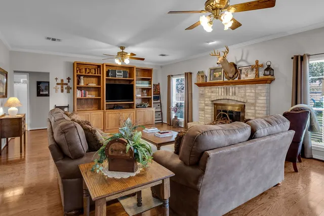a living room with furniture a fireplace and a flat screen tv