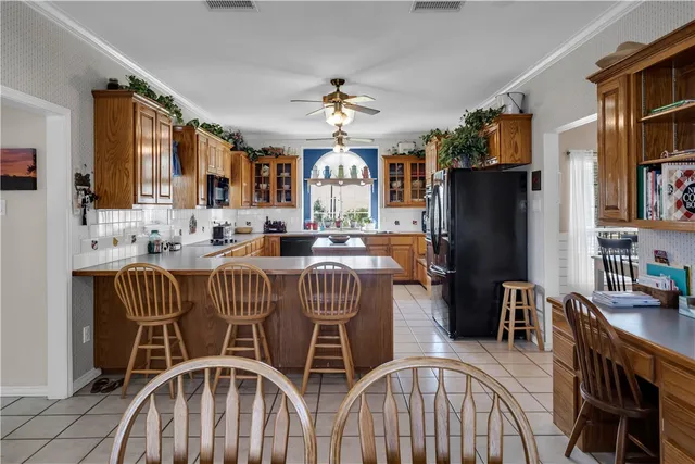 a dining room with furniture a chandelier and window