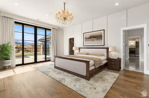 1141 East Lost Ridge Drive Washington, UT 84780 - Photo 61 of 108 Spacious room featuring wide plank wood-finish flooring, a contemporary chandelier, and large glass panel doors opening to an outdoor patio