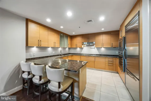 a kitchen with stainless steel appliances granite countertop a sink and cabinets