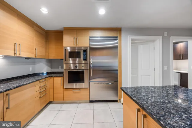 a kitchen with granite countertop lots of counter top space and stainless steel appliances