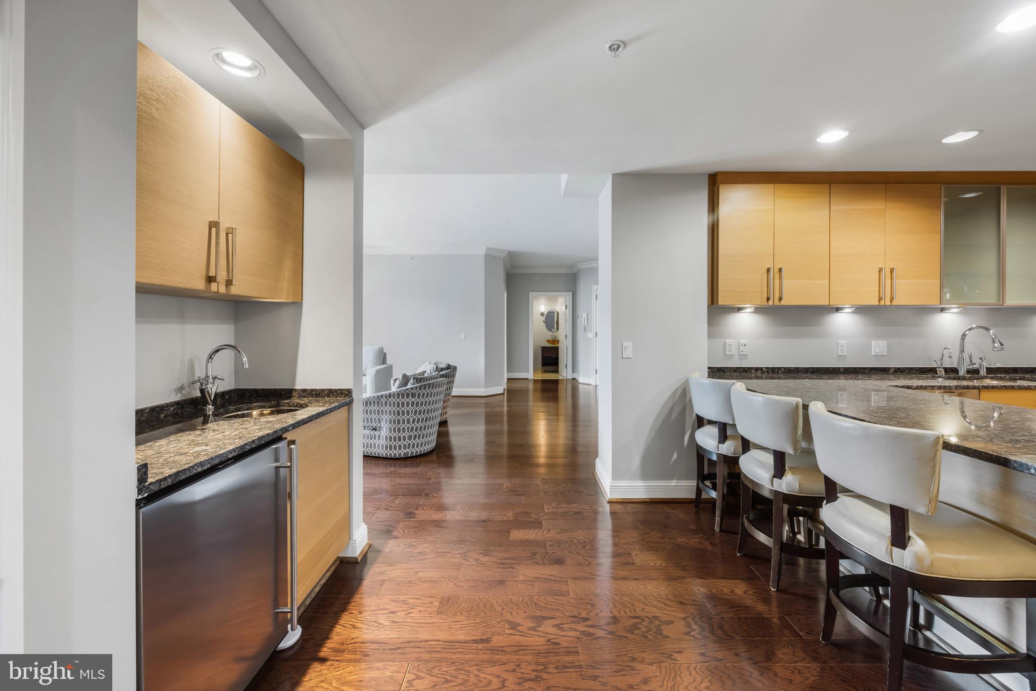 801 Key Highway, Unit 323 Baltimore, MD 21230 - Photo 16 of 56 a kitchen with granite countertop lots of counter top space and stainless steel appliances