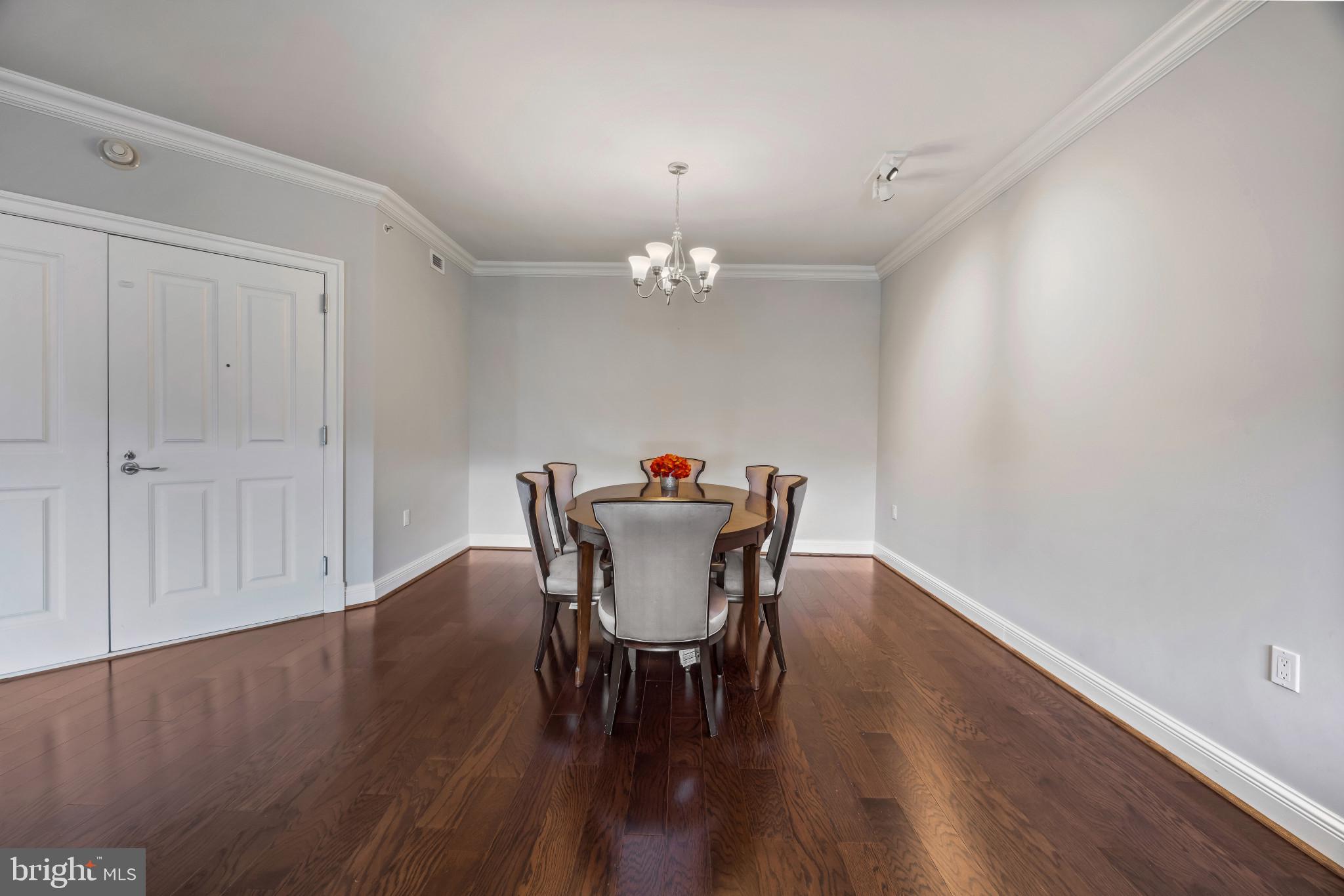 801 Key Highway, Unit 323 Baltimore, MD 21230 - Photo 20 of 56 a dining room with furniture a chandelier and wooden floor