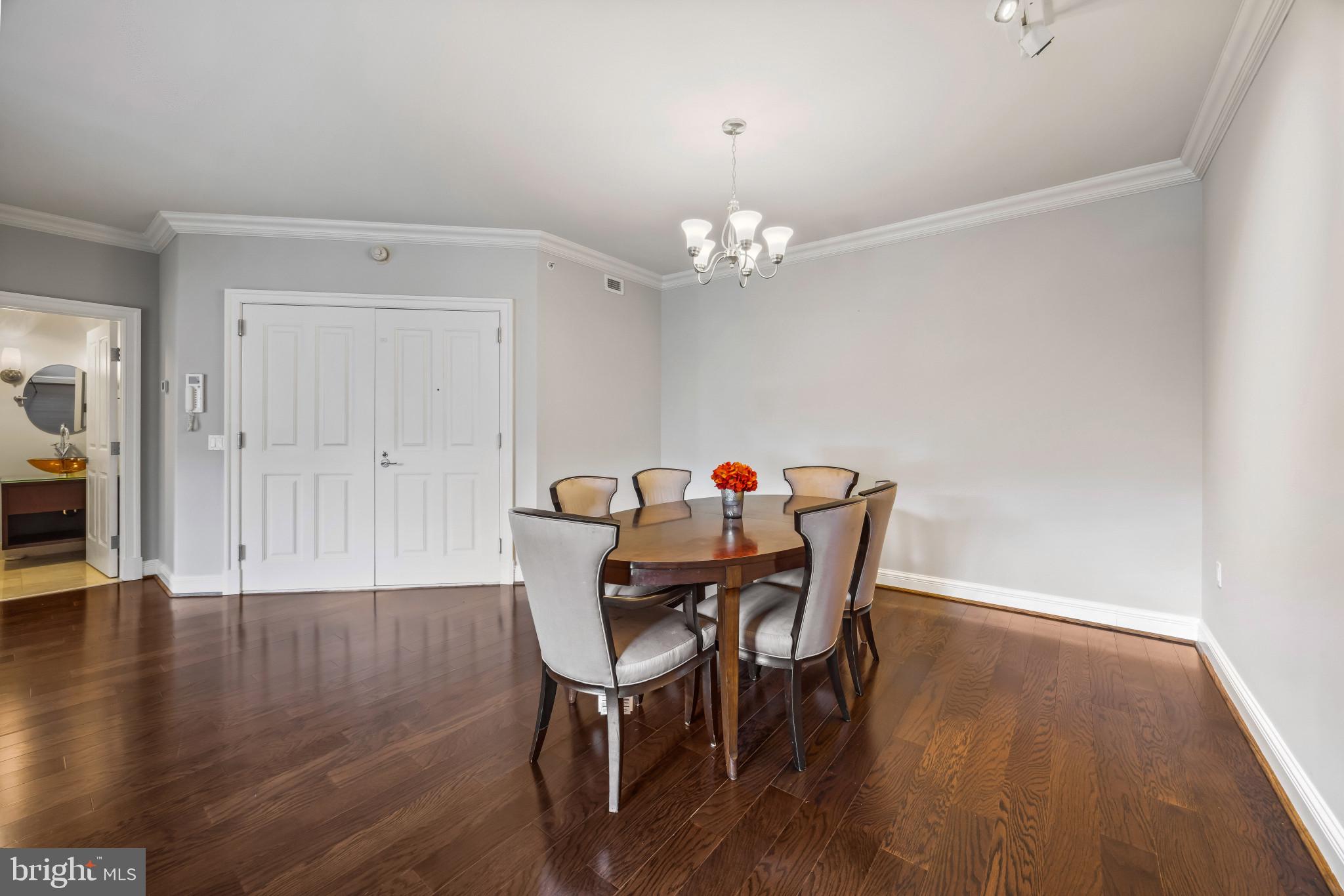 801 Key Highway, Unit 323 Baltimore, MD 21230 - Photo 21 of 56 a view of a dining room with furniture and wooden floor