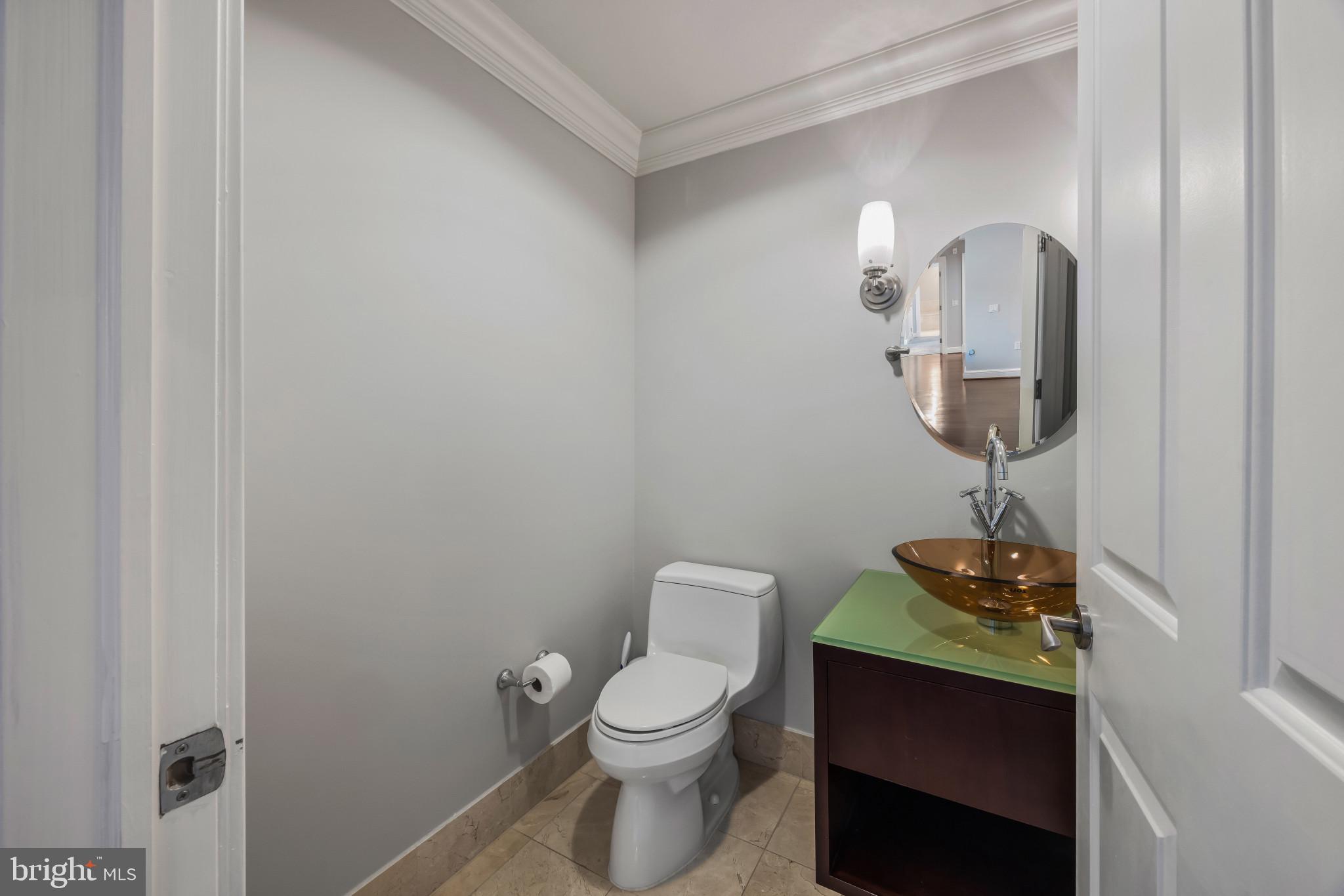 801 Key Highway, Unit 323 Baltimore, MD 21230 - Photo 22 of 56 a bathroom with a toilet a sink and mirror