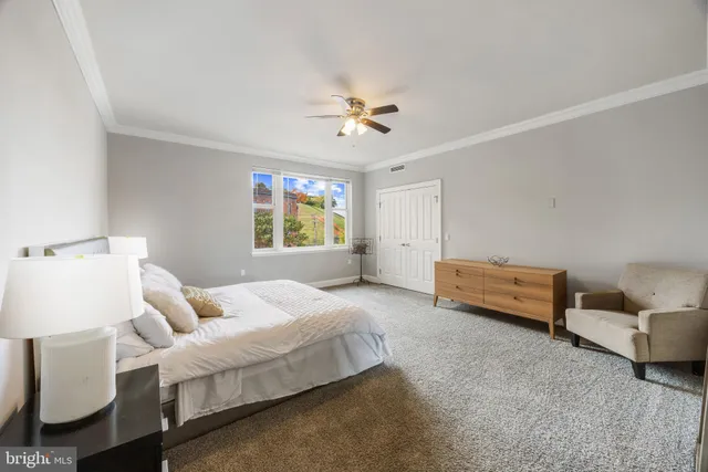 a bedroom with a large bed and a window