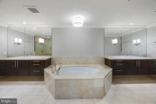 a bathroom with a double vanity sink mirror and toilet
