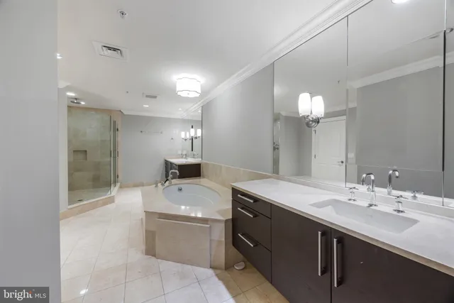 a bathroom with a bathtub shower sink and mirror