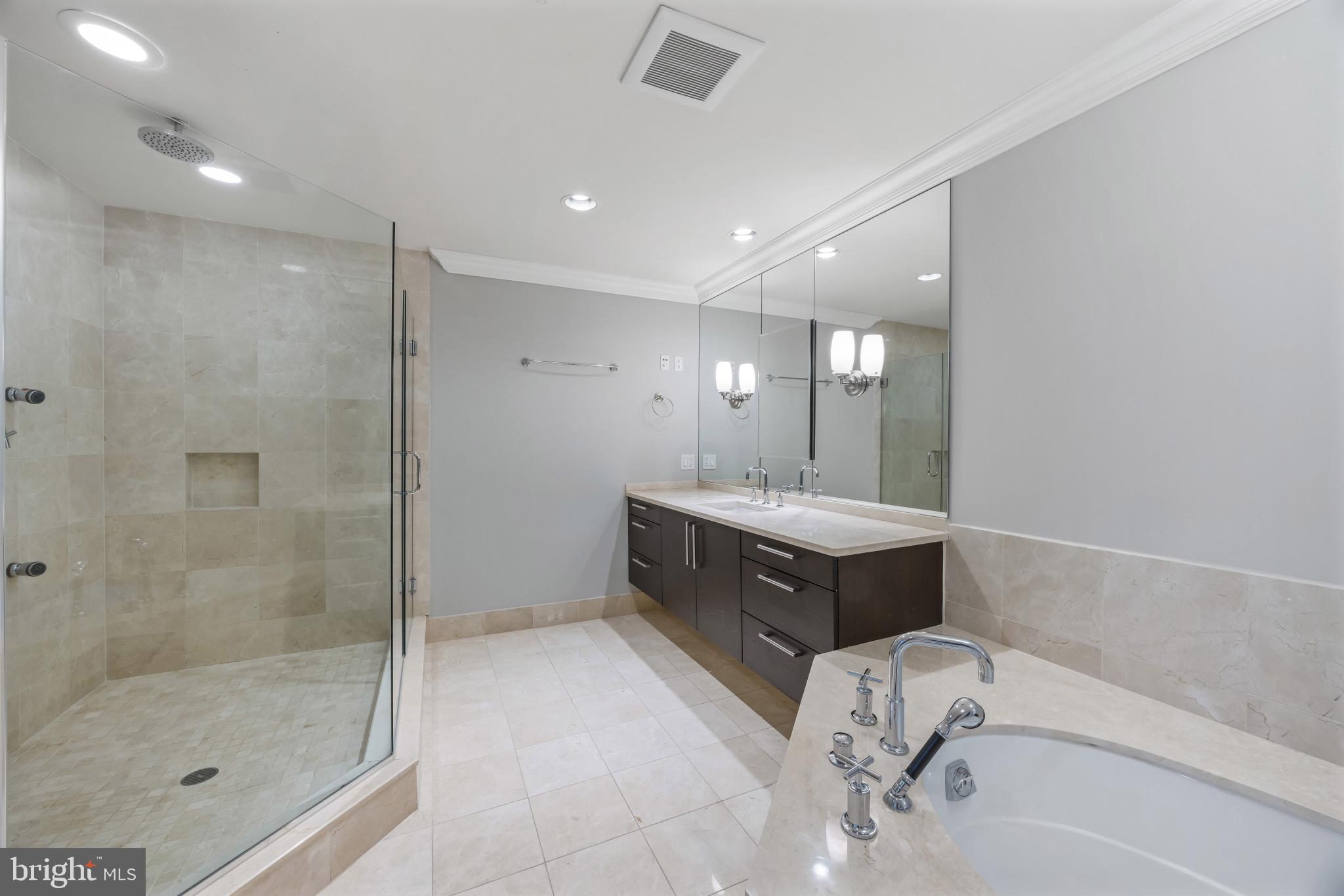 801 Key Highway, Unit 323 Baltimore, MD 21230 - Photo 31 of 56 a bathroom with a tub sink shower and mirror