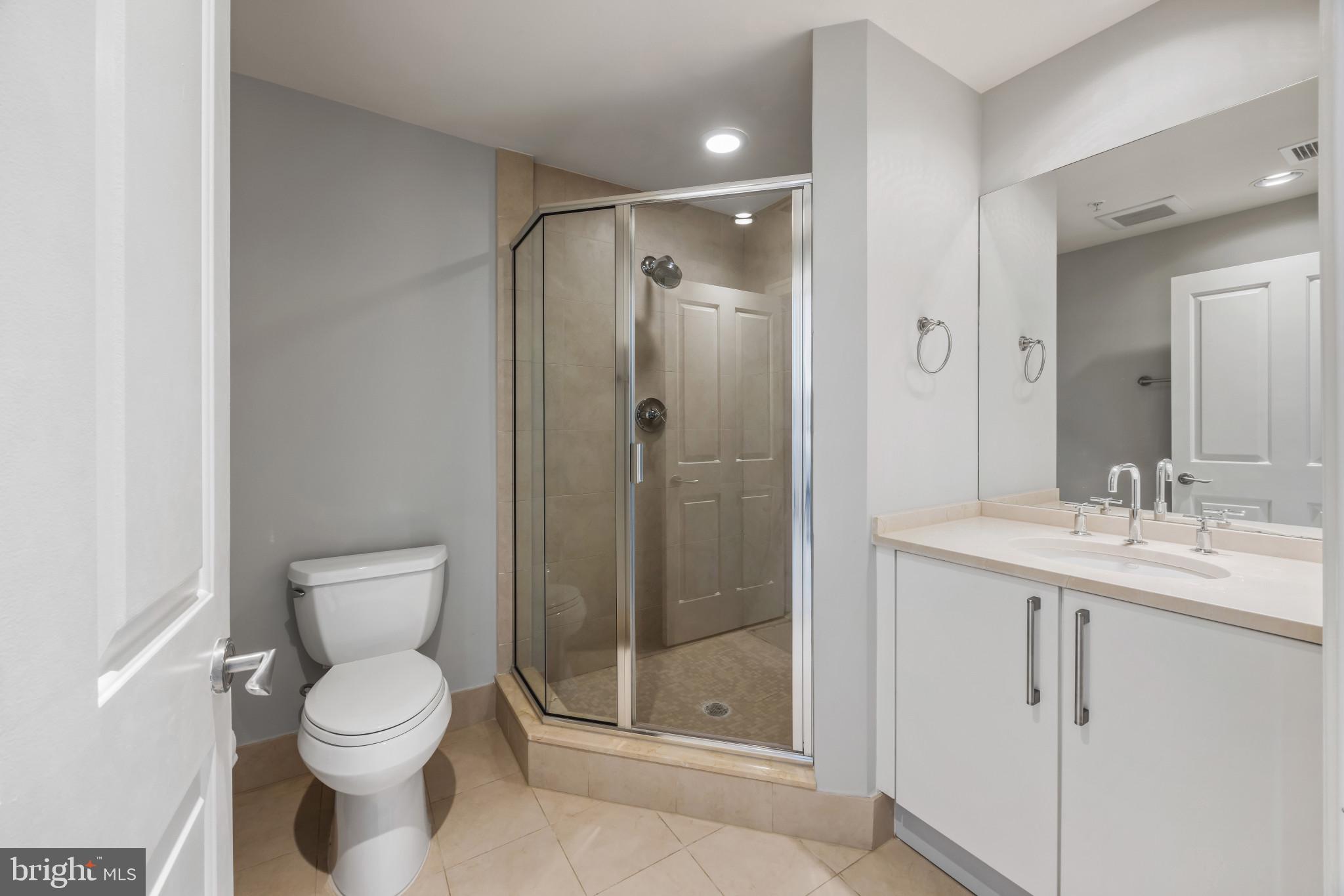 801 Key Highway, Unit 323 Baltimore, MD 21230 - Photo 39 of 56 a bathroom with a toilet sink vanity and shower