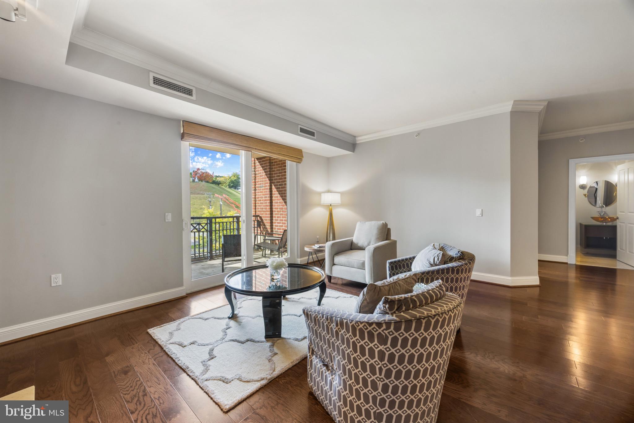 801 Key Highway, Unit 323 Baltimore, MD 21230 - Photo 6 of 56 a living room with furniture and wooden floor