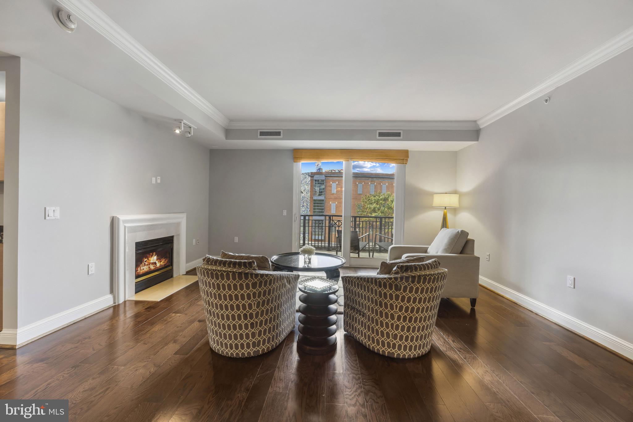 801 Key Highway, Unit 323 Baltimore, MD 21230 - Photo 8 of 56 a living room with furniture and a fireplace