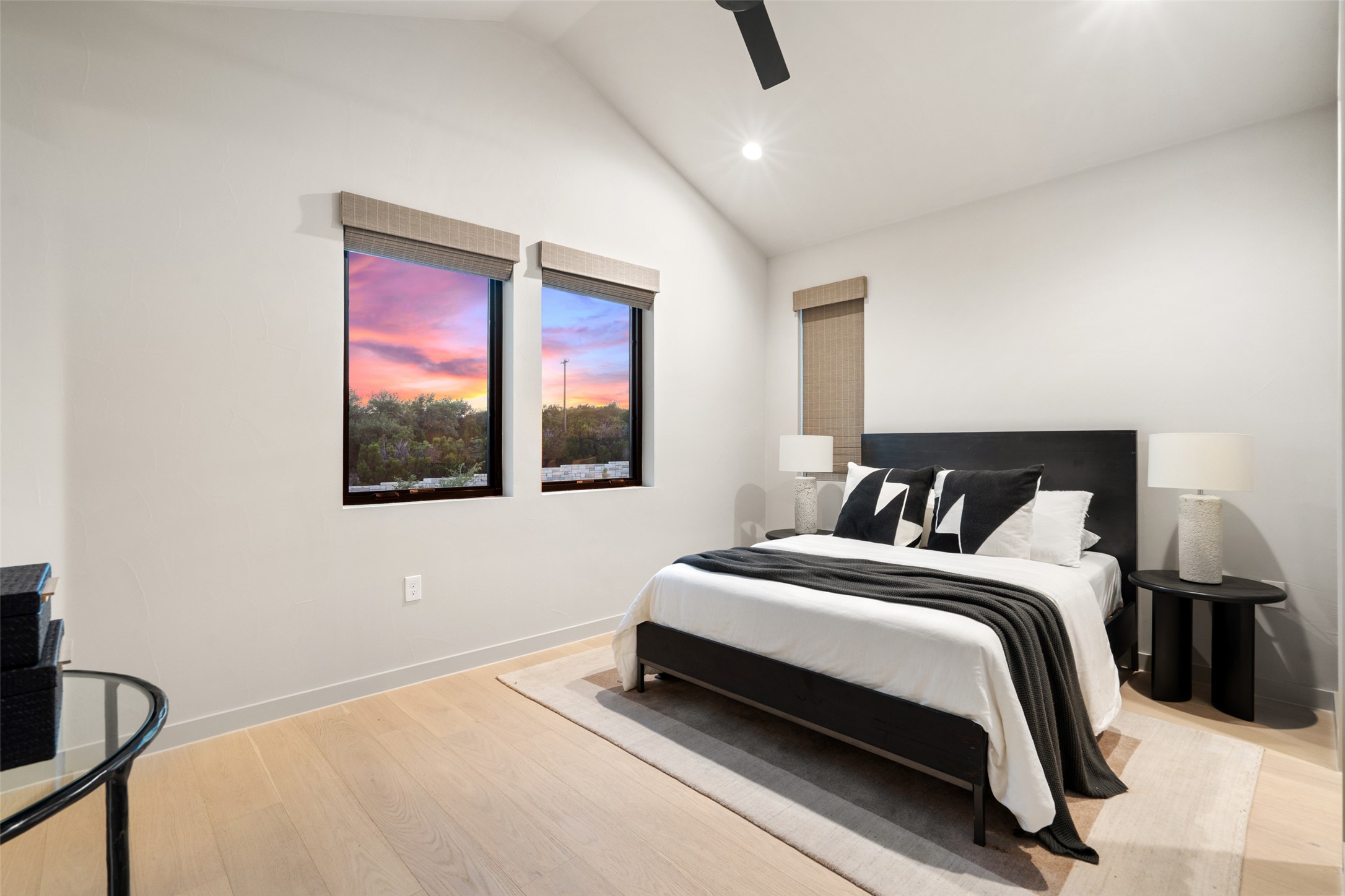 9803 Ribelin Ranch Court, Unit 6 Austin, TX 78750 - Photo 24 of 31 Slanted high ceilings and numerous windows fill this serene bedroom with natural light and scenic views.