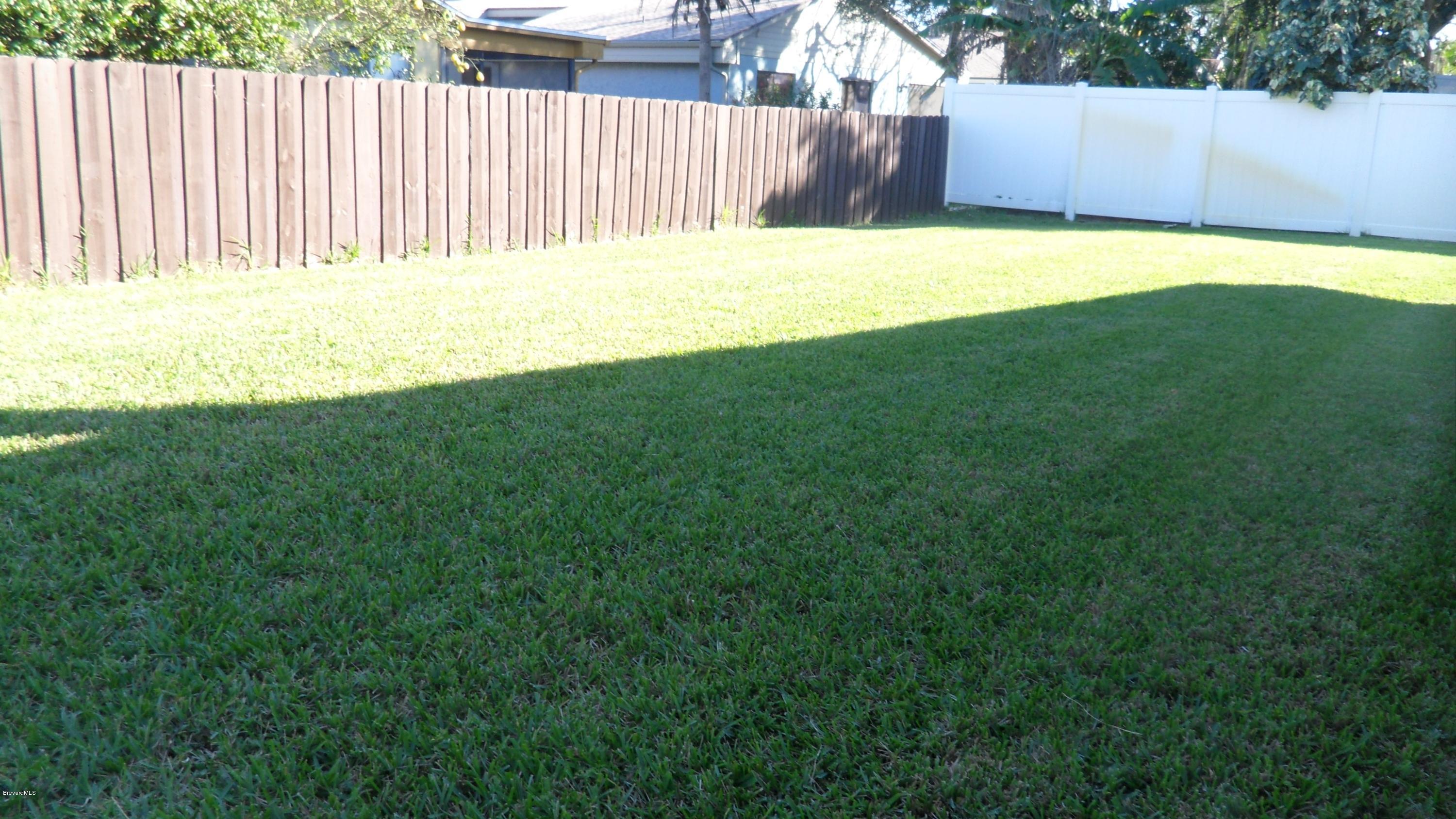 407 Myrtlewood Road Melbourne, FL 32940 - Photo 8 of 31 Partially fenced Backyard