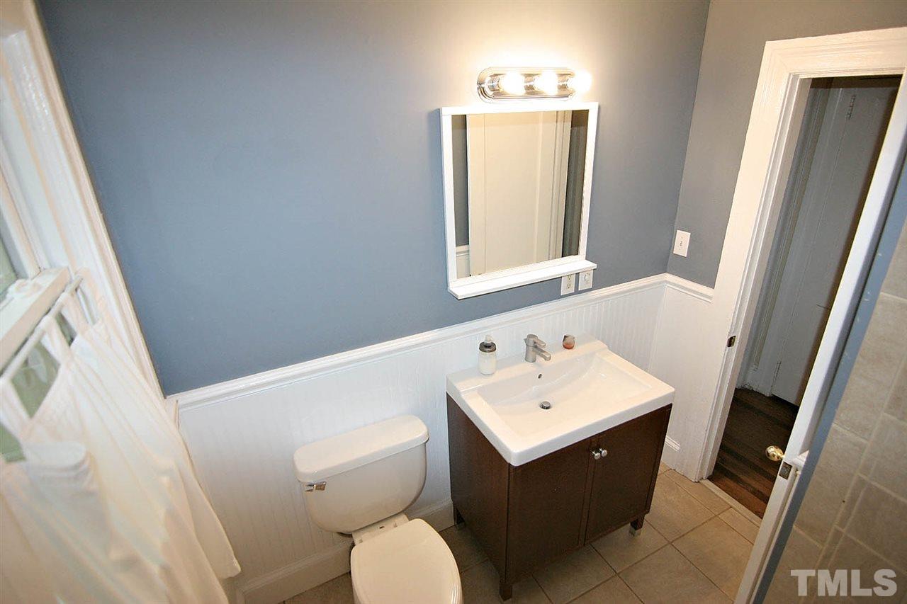 623 Monroe Drive Raleigh, NC 27604 - Photo 14 of 18 a bathroom with a sink toilet and mirror