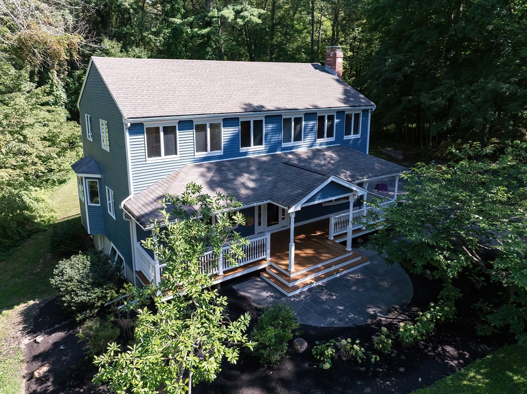 an aerial view of a house with a yard and potted plants
