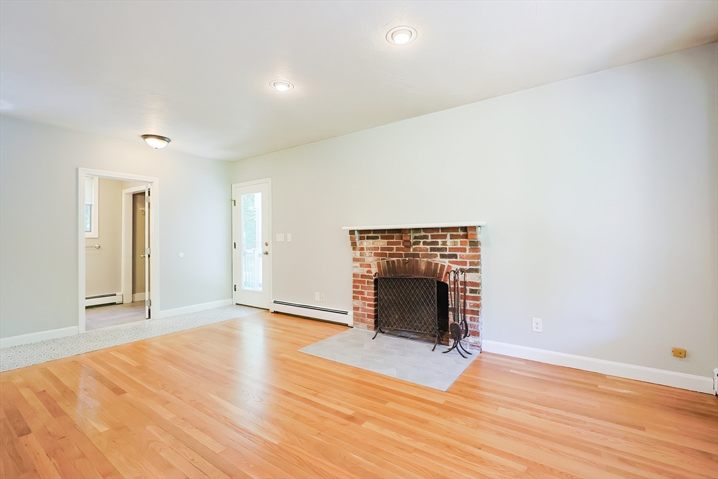 10 Prospect Street Upton, MA 01568 - Photo 13 of 41 a view of an empty room with wooden floor fireplace and a window