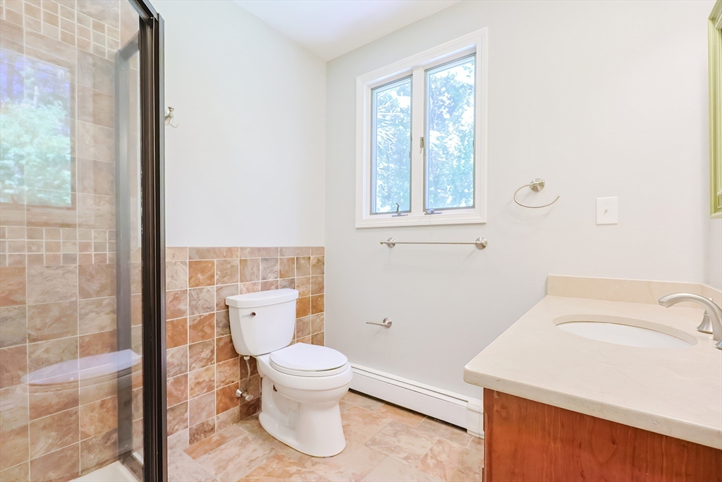 10 Prospect Street Upton, MA 01568 - Photo 22 of 41 a white toilet sitting next to a bathroom sink