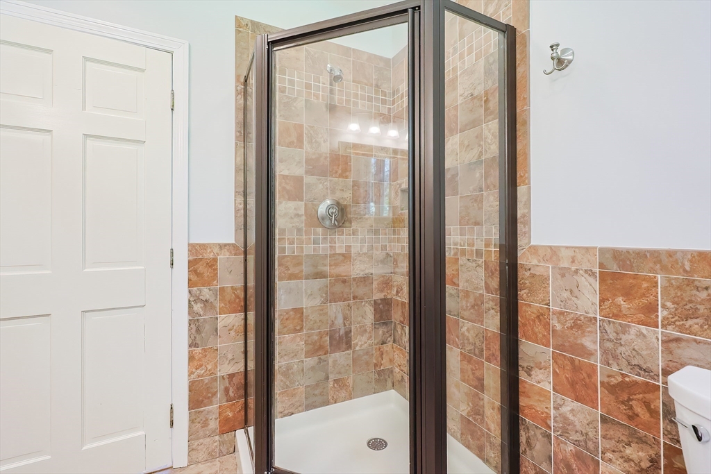 10 Prospect Street Upton, MA 01568 - Photo 23 of 41 a bathroom with a glass shower door