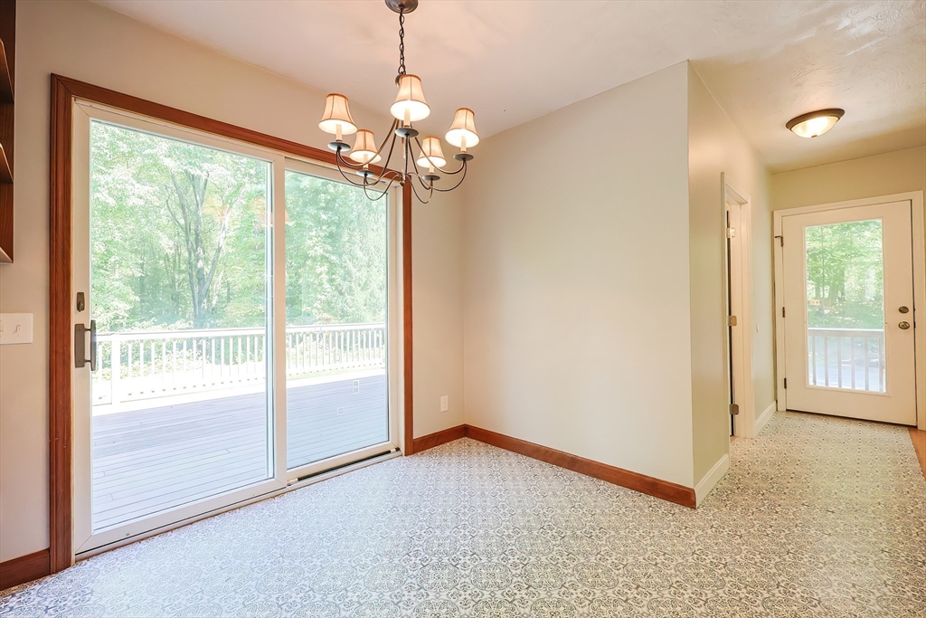 10 Prospect Street Upton, MA 01568 - Photo 7 of 41 a view of a livingroom with a chandelier curtains and large windows