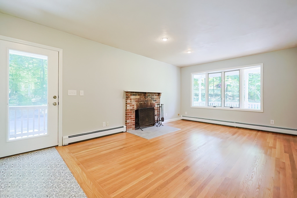 10 Prospect Street Upton, MA 01568 - Photo 10 of 41 an empty room with wooden floor fireplace and windows
