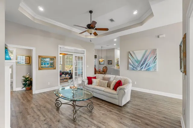 a living room with furniture potted plant and window