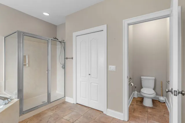 a bathroom with a toilet shower and a sink