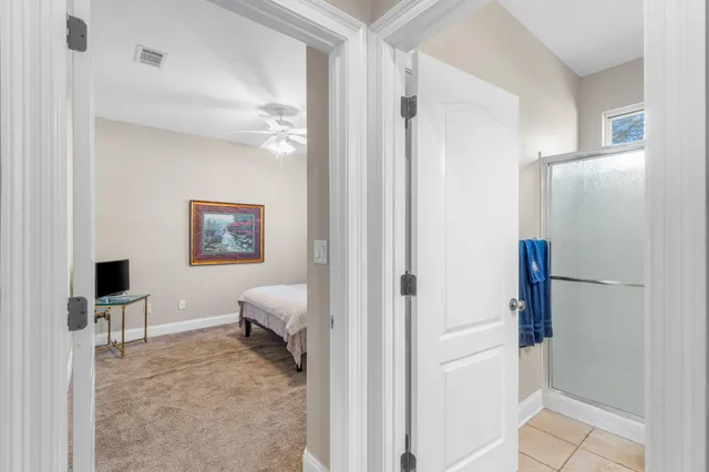 a en suite bathroom with a toilet sink and a mirror