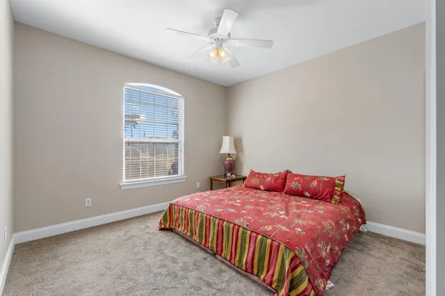 a bedroom with a bed and window