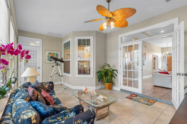 a living room with furniture and flowers