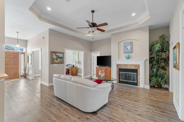 a living room with furniture a fireplace and a flat screen tv