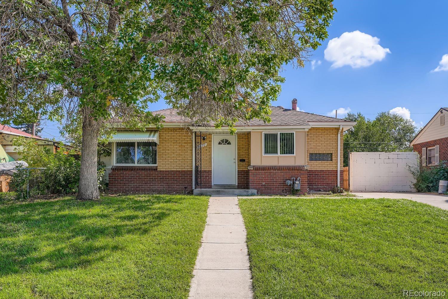 3670 Magnolia Street Denver, CO 80207 - Photo 1 of 26 a front view of a house with a yard and large tree