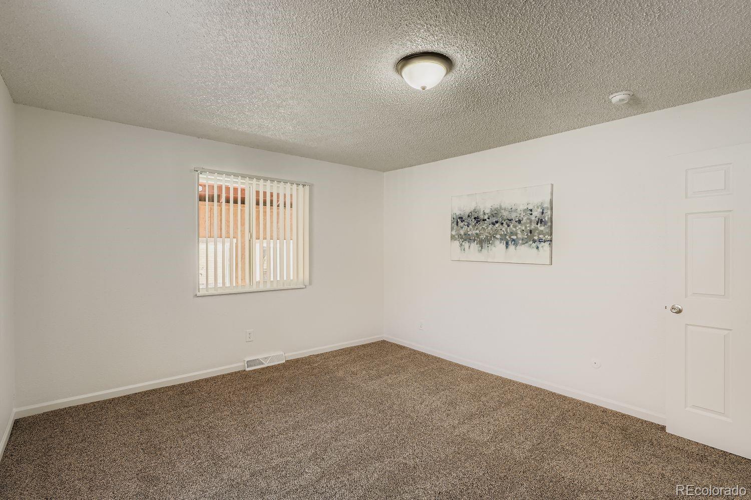 3670 Magnolia Street Denver, CO 80207 - Photo 13 of 26 an empty room with a window