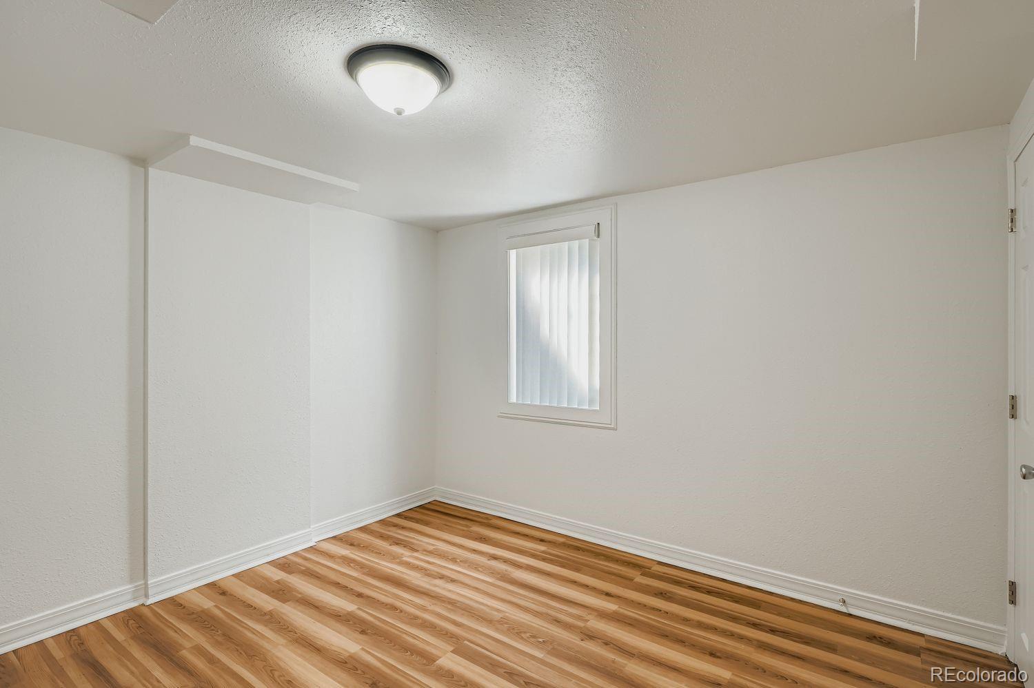 3670 Magnolia Street Denver, CO 80207 - Photo 17 of 26 an empty room with a window