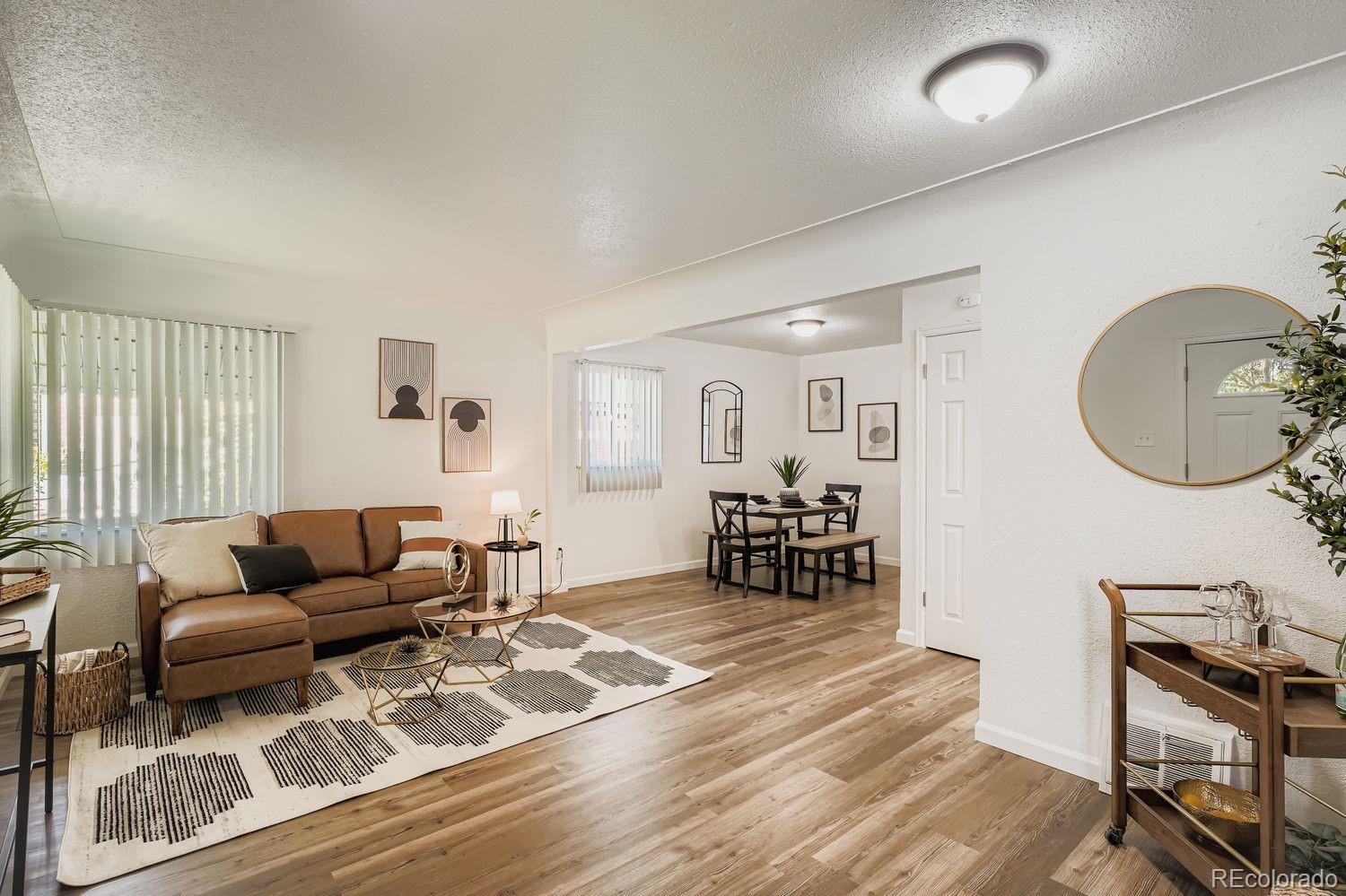 3670 Magnolia Street Denver, CO 80207 - Photo 2 of 26 a living room with furniture and a wooden floor