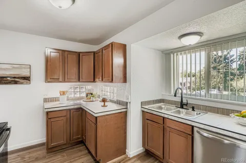 a kitchen with sink and large window