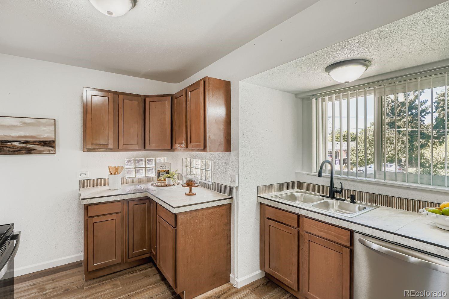 3670 Magnolia Street Denver, CO 80207 - Photo 4 of 26 a kitchen with sink and large window